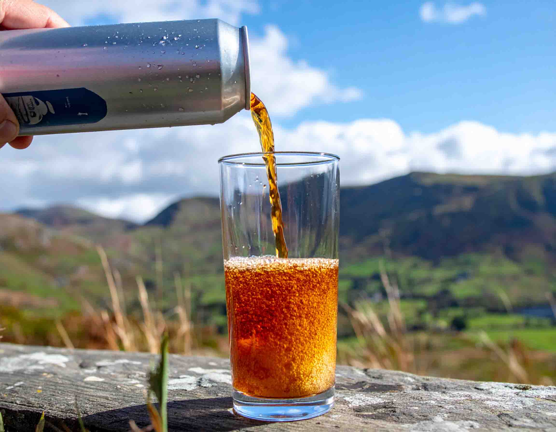 Energy drink being poured into glass in Cumbrian setting